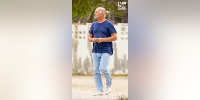 A man in a blue t-shirt and jeans