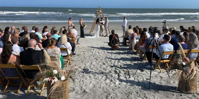 Aric Hutchinson and Samantha Miller tie the knot on the beach.