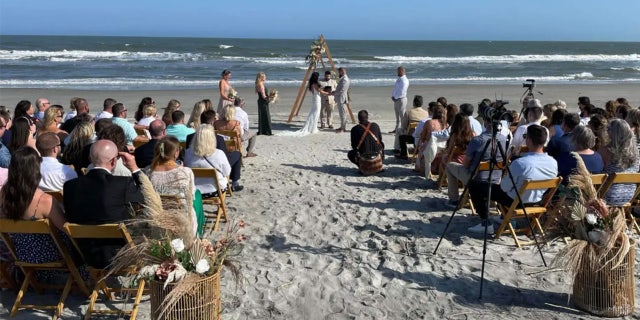 Aric Hutchinson and Samantha Miller tie the knot on the beach.