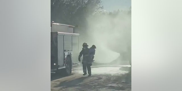 firefighter carrying child
