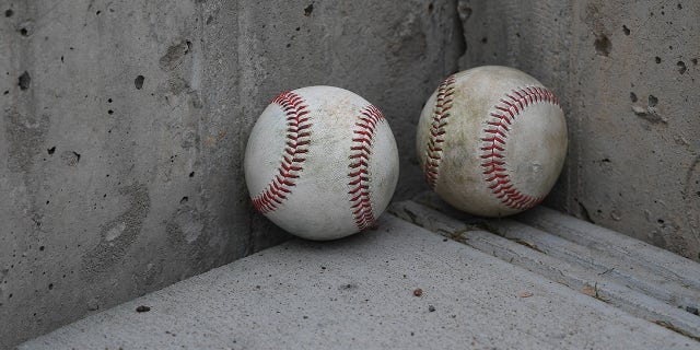 two baseballs on the ground