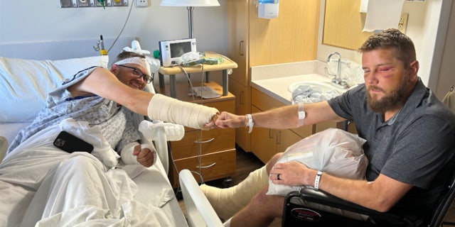 Benjamin Garrett and Aric Hutchinson in a hospital room.