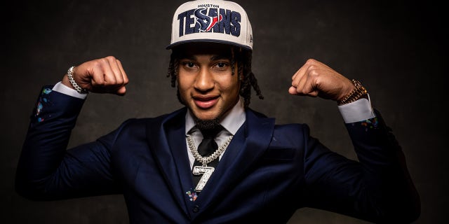 CJ Stroud flexes in pose