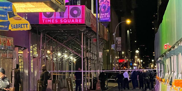 Police assembled outside a hotel at night