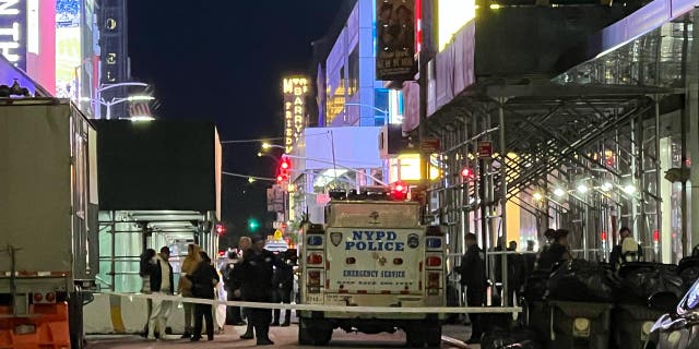 Police assembled outside a hotel at night