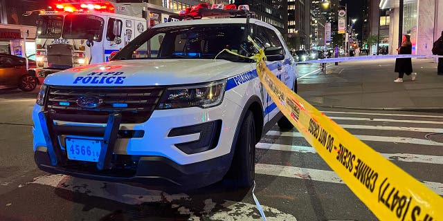 Police assembled outside a hotel at night