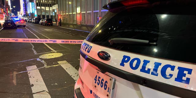 Police assembled outside a hotel at night