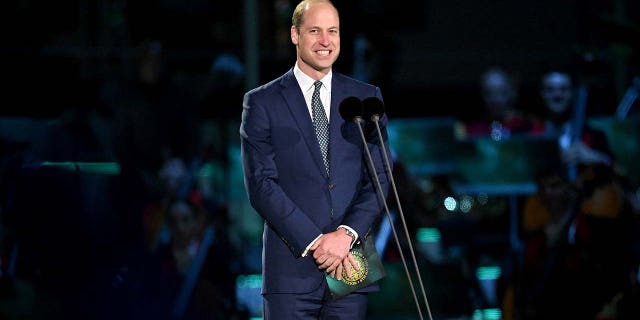 The Prince of Wales wears a blue suit and tie at coronation concert