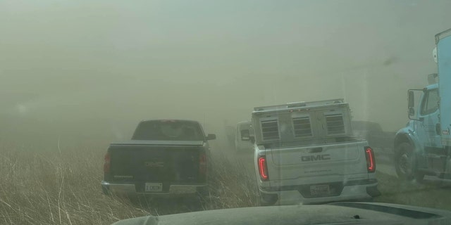 Vehicles shrouded in dust