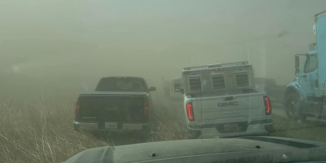 Vehicles shrouded in dust