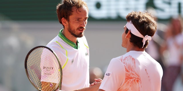 Daniil Medvedev shakes hands with Thiago Seyboth