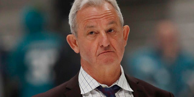 Darryl Sutter looks onto the ice