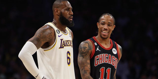 LeBron James and DeMar DeRozan look on during a game