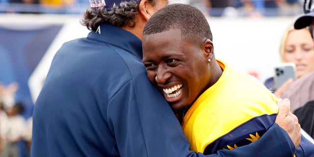 Derrick Dillon hugs Todd Haley