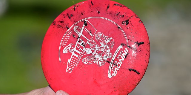 A disc golf with mud on it