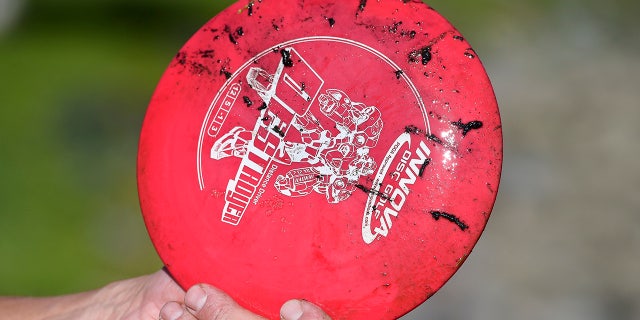 A disc golf with mud on it