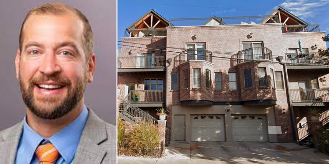 Stephen Matthews smiles in a portrait next to a brick townhome.