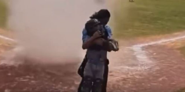 A dust devil forms at home plate