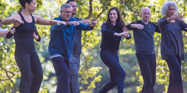 Robert De Niro and Anne Hathaway are pictured doing tai chi in a scene for their movie "The Intern" in a park - next to De Niro is martial arts instructor Tiffany Chen, who the actor is now in a relationship with