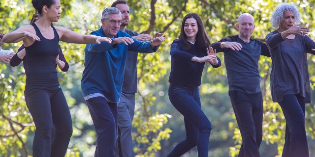 Robert De Niro and Anne Hathaway are pictured doing tai chi in a scene for their movie "The Intern" in a park - next to De Niro is martial arts instructor Tiffany Chen, who the actor is now in a relationship with