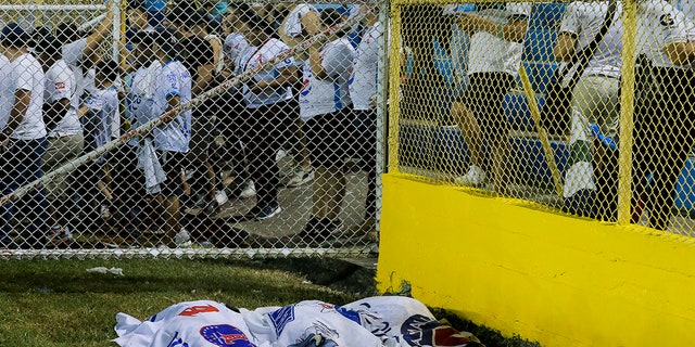 bodies covered with blankets at stadium