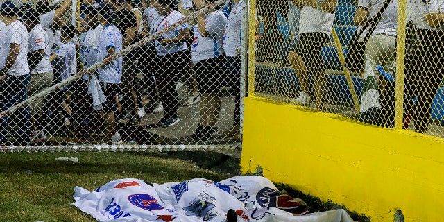 bodies covered in blankets at the stadium