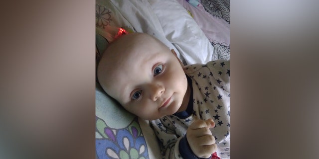 Toddler Finley Boden is pictured lying in his crib