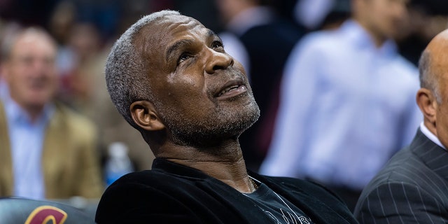 Former NBA player Charles Oakley sits court side