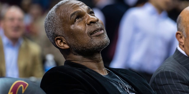 Former NBA player Charles Oakley sits courtside