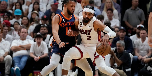 Miami Heat players guards a New York Knicks player