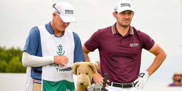 Patrick Cantlay consults with caddie Joe LaCava