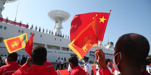 People wave Chinese flags in Sri Lanka