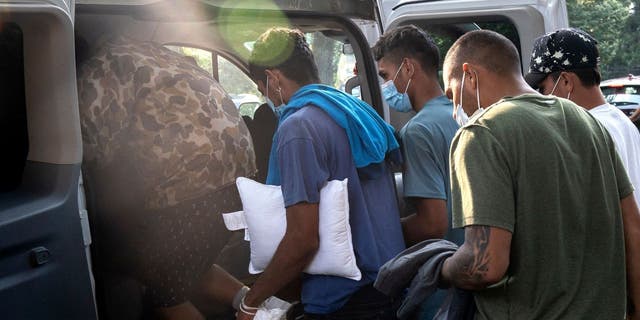 Migrants getting into van