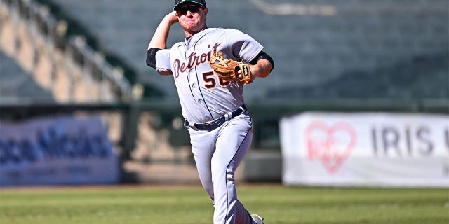 Colt Keith throws to first base
