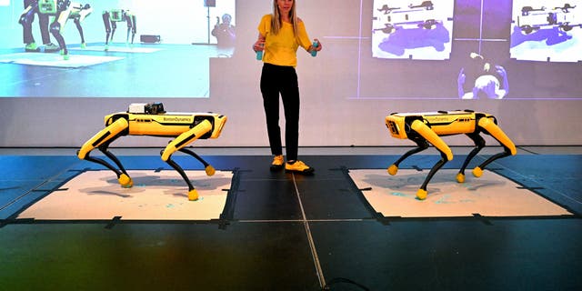 Agnieszka Pilat demonstrates a Boston Dynamics robot painting with AI technology in Melbourne.