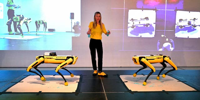 Agnieszka Pilat demonstrates a Boston Dynamics robot painting with AI technology in Melbourne.