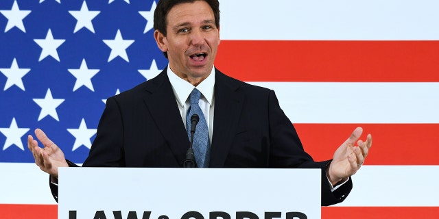 Florida Gov. Ron DeSantis speaking in front of American flag