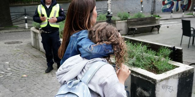 serbia parents holding children