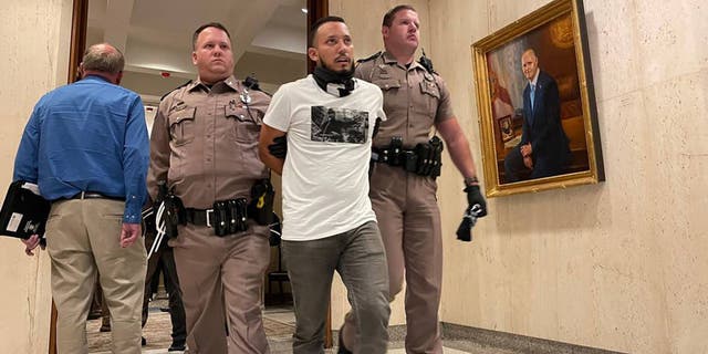 florida protesters being escorted out of desantis office