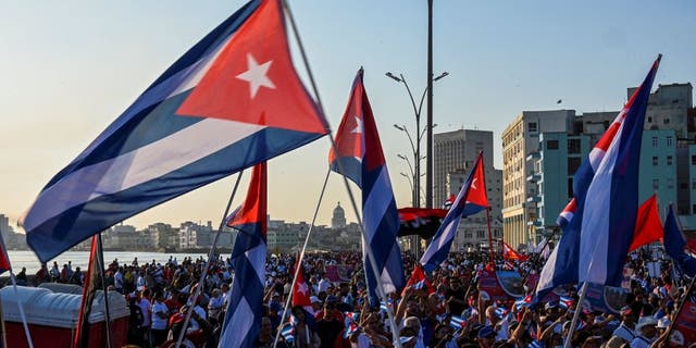 Protesters wave Cuban flags