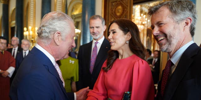 King Charles III (L) greets Mary, Crown Princess of Denmark and Crown Prince Frederik of Denmark,