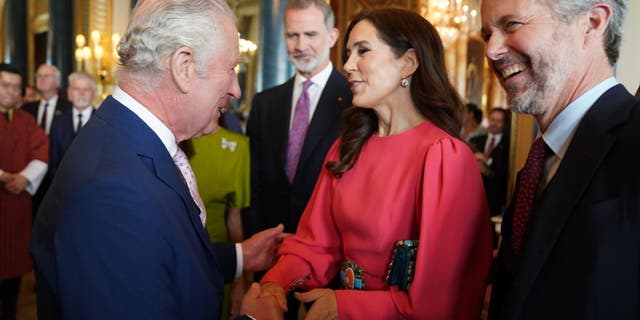 King Charles III (L) greets Mary, Crown Princess of Denmark and Crown Prince Frederik of Denmark,