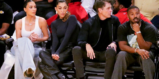 Kim Kardashian sits next to designer Sarah Staudinger and two people over is Michael B. Jordan, all sitting courtside at the Lakers game