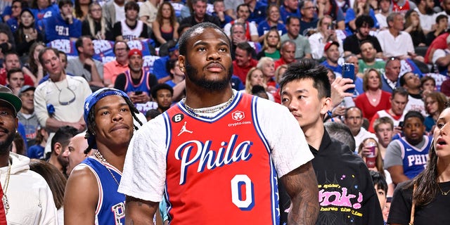 Micah Parsons at an NBA game wearing a 76ers jersey