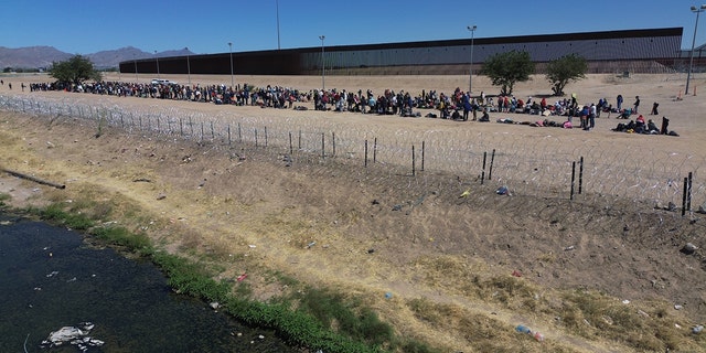 Migrants wait at the border