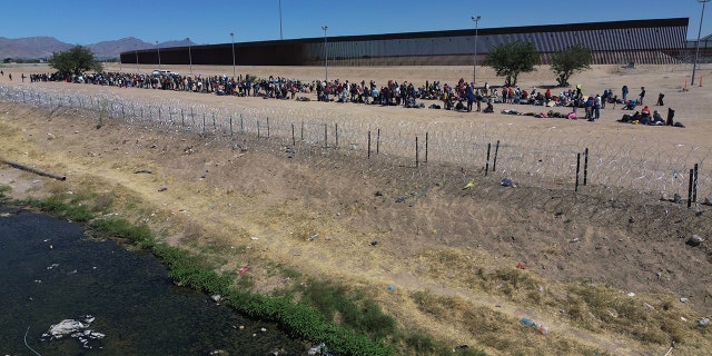 Migrants wait at the border