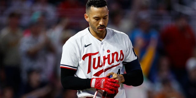 Carlos Correa reacts after striking out