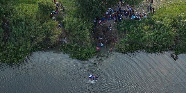 An aerial photo of migrants in water