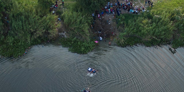 An aerial photo of migrants in water