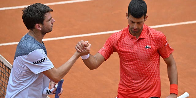Cameron Norrie and Novak Djokovic shake hands at the Italian Open